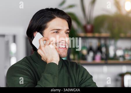 Excited businessman talking to business clients on phone Stock Photo