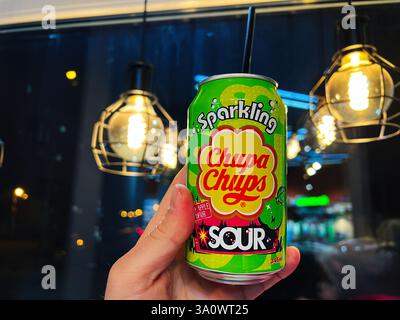 Kyiv, Ukraine - March 04, 2025: Brightly lit urban background highlighting Chupa Chups sparkling beverage in vibrant colors Stock Photo
