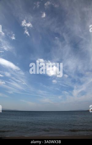 Blue Sky with Wispy Clouds over Aegean Sea Vouliagmeni Beach Athens Attica Greece Stock Photo