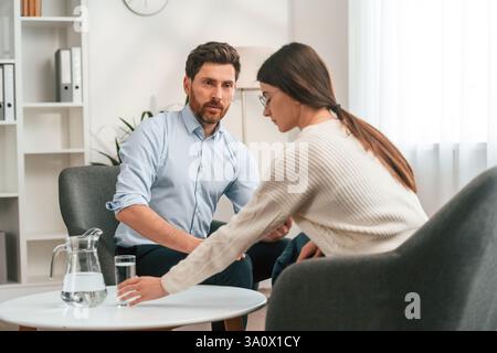 With woman. Psychologist is working in the cabinet. Stock Photo