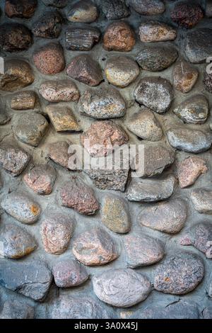 Background with the texture of masonry or cobblestone pavement. An ancient stone wall. Close-up. High quality photo Stock Photo