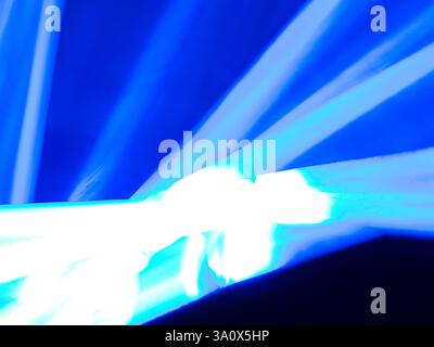 Abstract picture of white and blue streaks of light against a blue background Stock Photo