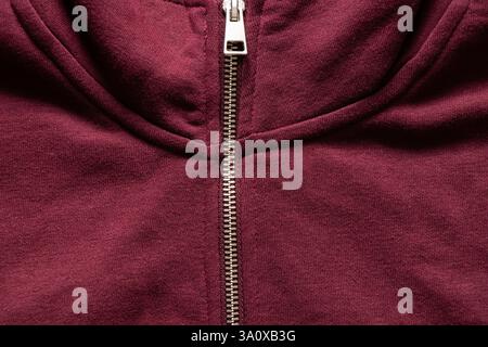 Red warm sweater with zipper as background, synthetic material, red clothes Stock Photo