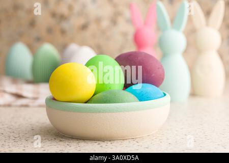 Easter decoration. Colorful eggs on kitchen table. Stock Photo