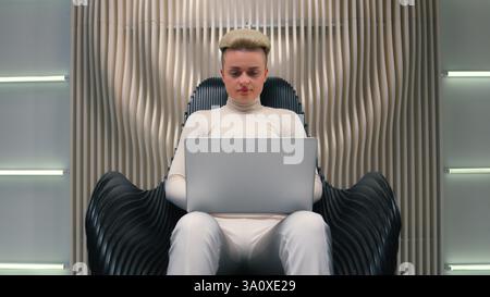 Caucasian woman girl in white neon futuristic space female IT programmer hacker coder gamer hacker software computer tech support typing laptop addict Stock Photo
