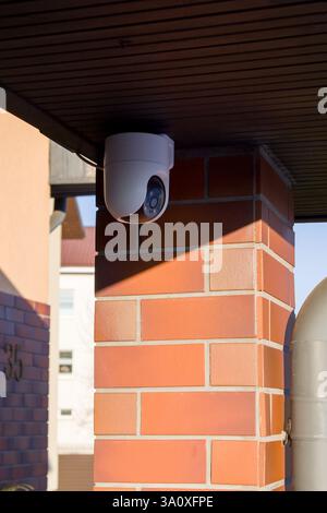 A view of an outdoor surveillance camera mounted on the wall of a private residential house Stock Photo