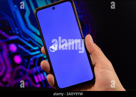 BOGOTA, COLOMBIA - MARCH 05 OF 2025 A male hand holding a smartphone with deepseek software logo and blurred technology background Stock Photo