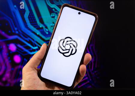 BOGOTA, COLOMBIA - MARCH 05 OF 2025 A male hand holding a smartphone with chat GPT software Logo and ai blurred background Stock Photo