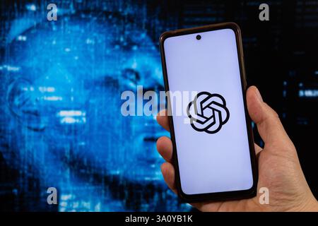 BOGOTA, COLOMBIA - MARCH 05 OF 2025 Macro photo of male hand holding a smartphone with chat gpt symbol with a blurred technology concept backgroud Stock Photo