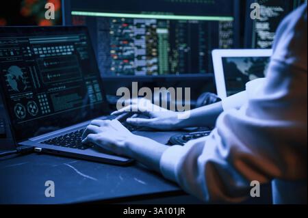 Close up view of female hacker hands, typing on keyboard. Stock Photo