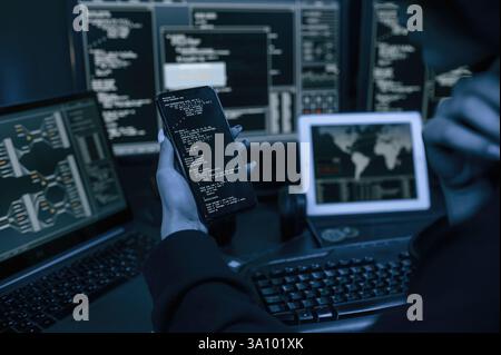 Close up view of female hacker hands, holding smartphone. Stock Photo