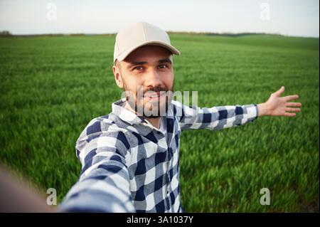 Making selfie. Handsome young man is on agricultural field. Stock Photo