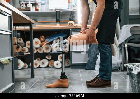 Prosthesis on the floor. Technician working in modern laboratory. Stock Photo