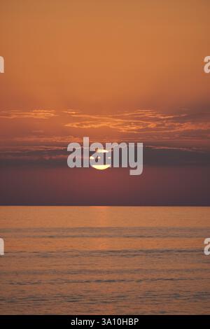 Golden sunset over the Tyrrhenian Sea horizon with dramatic clouds, viewed from the coast of Diamante, Calabria, Italy. Stock Photo
