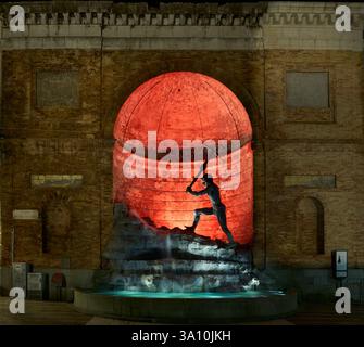 Night view of 'Il Cavatore' monument (The Quarryman) by sculptor Giuseppe Rito, illuminated by red light and set in a niche of the San Giovanni comple Stock Photo