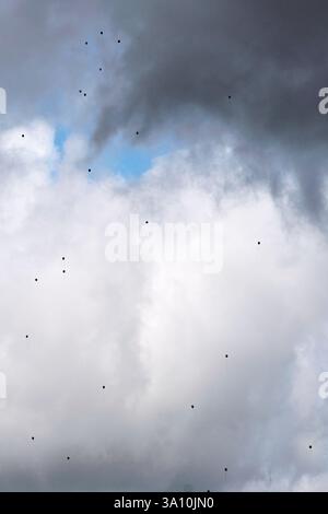 Low angle view of dark storm clouds and bright sky patches over the Sila mountains, Lorica, Calabria, Italy. Stock Photo