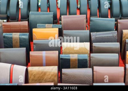 close-up shot of various leather wallets in different colors, neatly arranged at a retail stall. Stock Photo