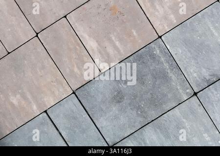 Multicolored paving slabs for road paving by mosaic on shop window. Construction Stock Photo