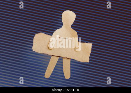 Paper man shape holding burnt note paper in hand Stock Photo