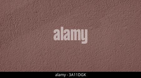 Background of brown decorative plaster, with pits and grooves in random directions in the surface. Shined by the sun with shaded area Stock Photo