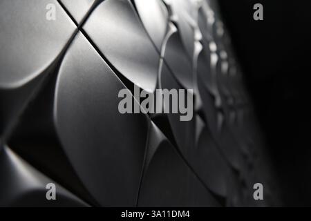 A black and white abstract image of curved, overlapping shapes, creating a sense of depth and mystery through light and shadow play. Stock Photo