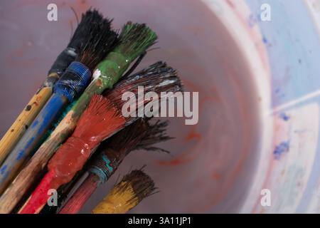 Paint brushes on technique ebru art on wooden background Stock Photo