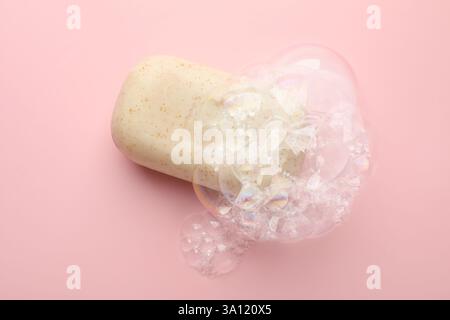 Soap bar with foam on light pink background Stock Photo
