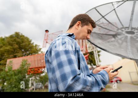 Radio telescope technician responsible for regular maintenance and repair of radio telescopes, antennas, and equipment. Stock Photo