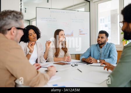 Business Team Discussing Strategy in Modern Office. Business Team Discussing Strategy in Modern Office Stock Photo