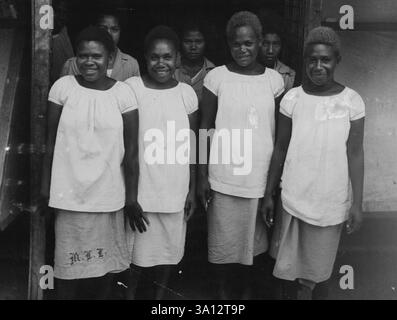 The native nursing staff at Rabaul Hospital the three nurses in the background had only just come from Moresby, were still petrified after the flight and did not like having their picture taken. June 23, 1953. (Photo by York Fiction-Feature Service). Stock Photo