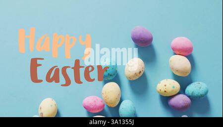 Image of happy easter text over easter eggs Stock Photo