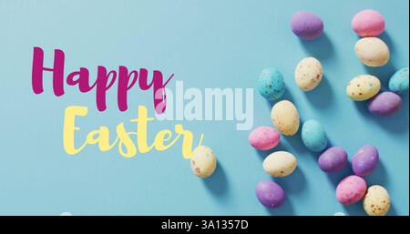 Image of happy easter text over easter eggs Stock Photo