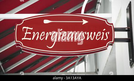 The picture shows a signpost and a sign in German that points in the direction of the energy certificate. Stock Photo