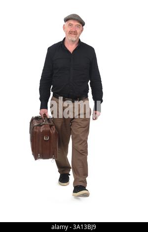 front view of a walking man carrying suitcase on white background Stock Photo