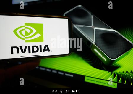 Roosendaal, The Netherlands - March 6, 2025: A mobile phone displaying the logo of NVIDIA, with the company website in the background. Stock Photo