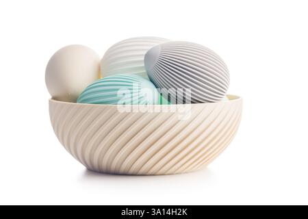Easter decoration. Colorful eggs in bowl isolated on a white background. Stock Photo