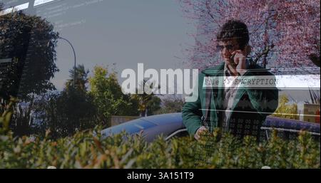Encryption and data security image over person using smartphone outdoors Stock Photo
