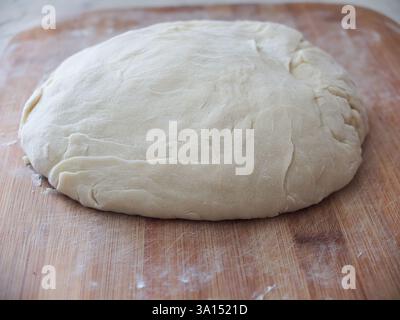 the baking dough is laid out on a board Stock Photo
