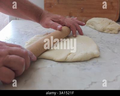 the baking dough is laid out on a board Stock Photo