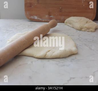 the baking dough is laid out on a board Stock Photo