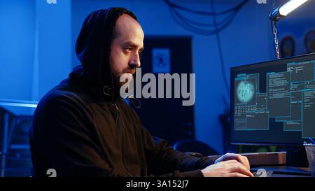 Hacker excited after finally developing zero day exploit undetectable by antivirus software installed on systems. Rogue programmer happy to successfully trick firewalls, celebrating accomplishment Stock Photo