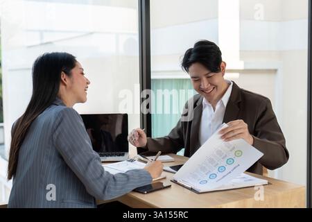 Dynamic teamwork. Professionals enjoying a collaborative session while discussing financial insights. Stock Photo