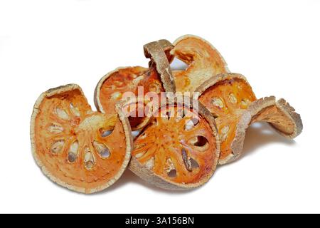 Close-up of dried fruit slices of the Bael plant, Aegle marmelos, isolated on white background, used to make a popular Thai herbal drink, nam matoom Stock Photo