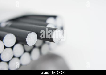 Cigarettes in a box on a white background close-up. Cigarettes with black filter. Smoking, Smoke Stock Photo