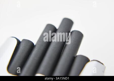 Cigarettes in a box on a white background close-up. Cigarettes with black filter. Smoking, Smoke Stock Photo