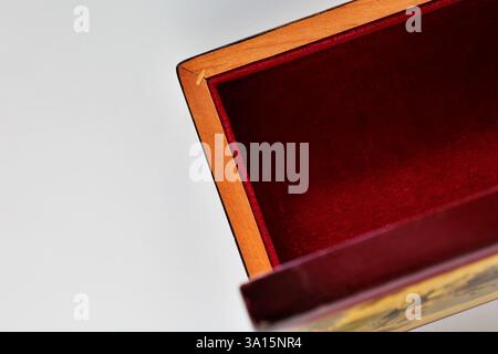 Detail of  empty opened wooden  jewelry box on white background Stock Photo