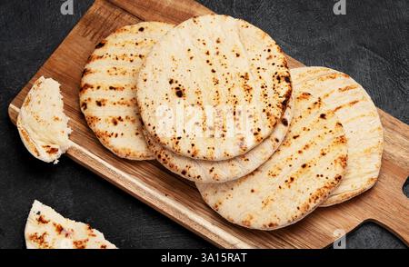 Pita bread isolated on a dark background. Traditional and typical food of Arabic cuisine. Stock Photo