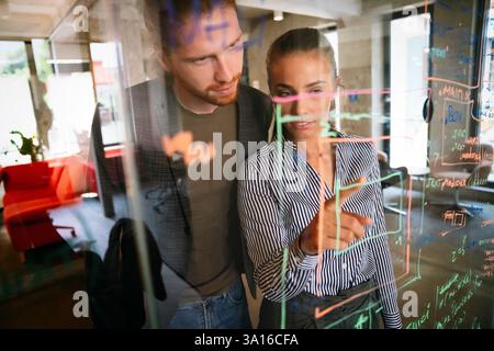 Software engineers working together on project at tech startup. Business designers working together Stock Photo