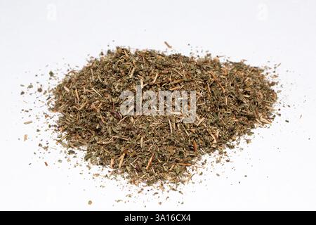 Dried raspberry leaf forming a small pile, ideal for herbal tea infusions and alternative medicine remedies Stock Photo