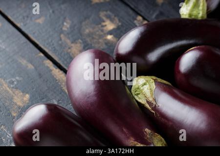 Heap of Ripe Eggplants on Dark Background, Eggplants Harvest, Copy Space Stock Photo